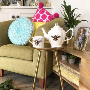 Insect teapot with bee mug on brass table
