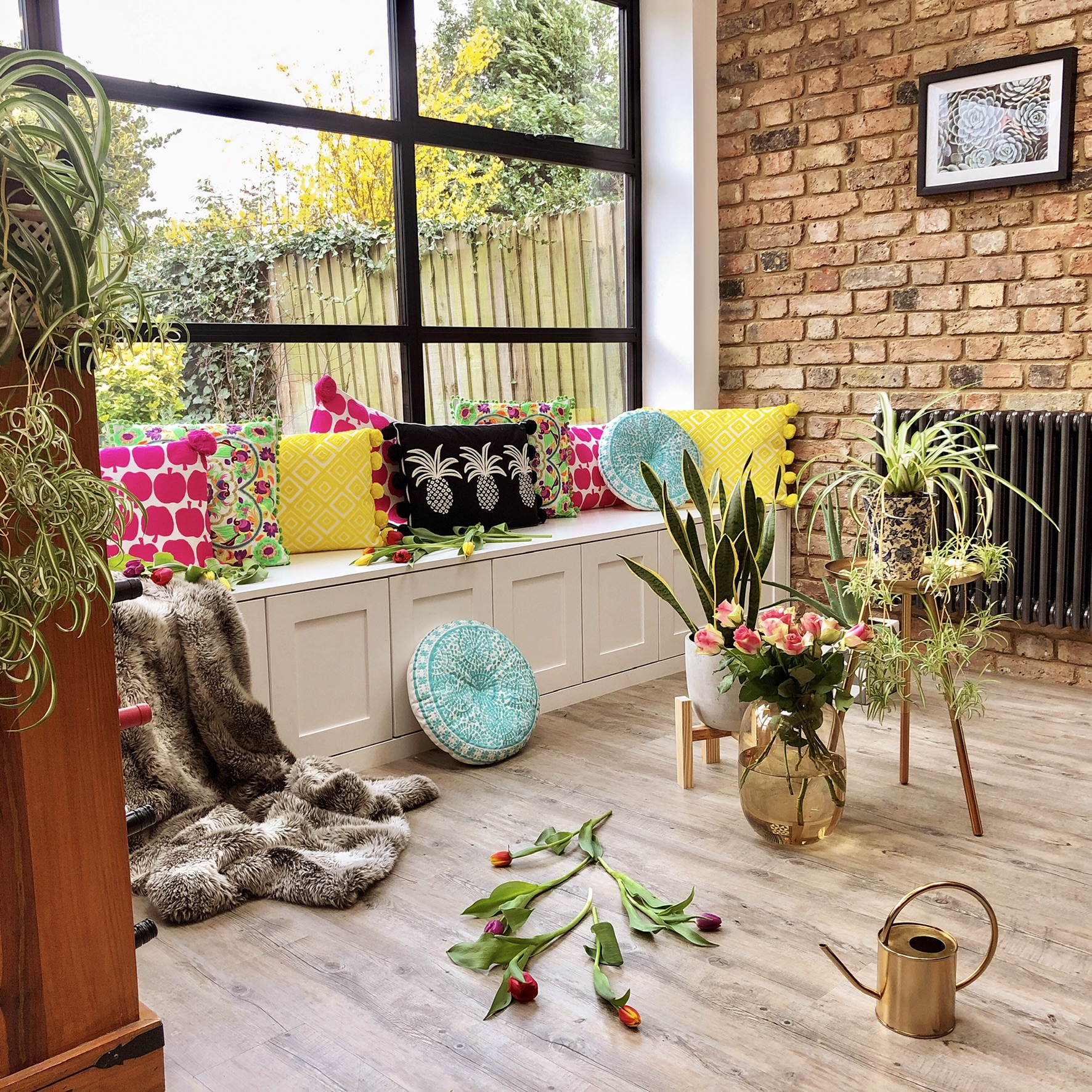 Cushions, brass table and concrete planter